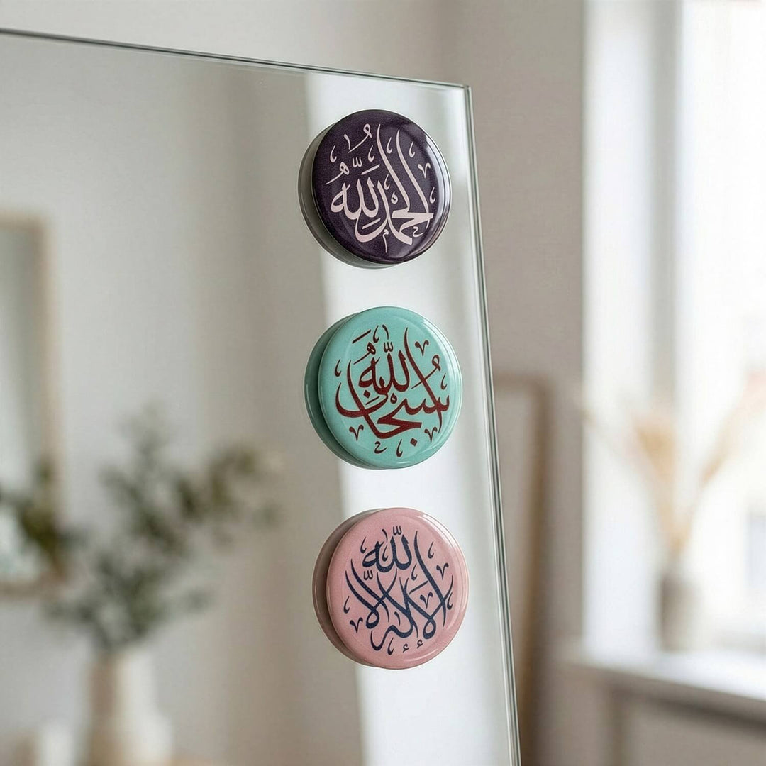 Three circular stickers with Arabic text on a mirror surface.