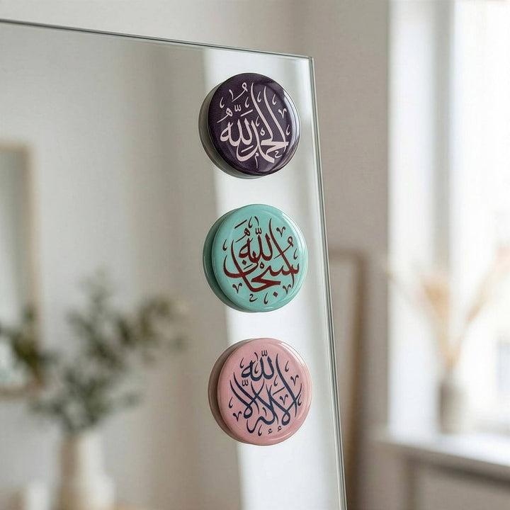 Three circular stickers with Arabic text on a mirror surface.