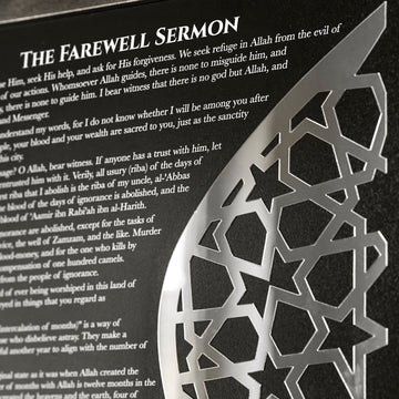 Close-up of the English Farewell Sermon text and the silver mirrored acrylic geometric crescent