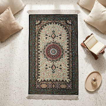 Floral Vine Prayer Rug in Black - Cream, top view on the floor next to a Quran stand and cushions