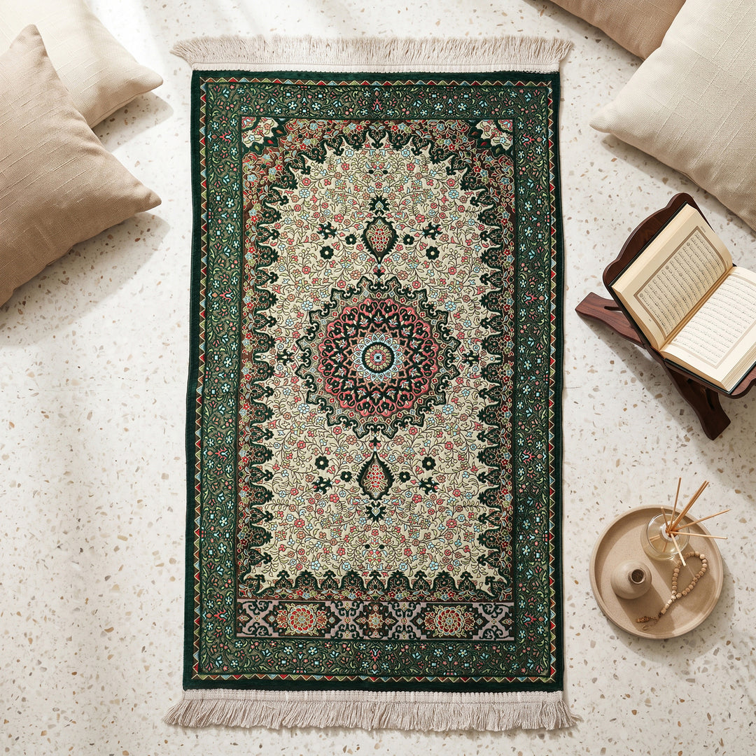 Floral Vine Prayer Rug in Emerald Green - Cream, top view on the floor next to a Quran stand and cushions