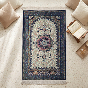 Floral Vine Prayer Rug in Navy - Cream, top view on the floor next to a Quran stand and cushions