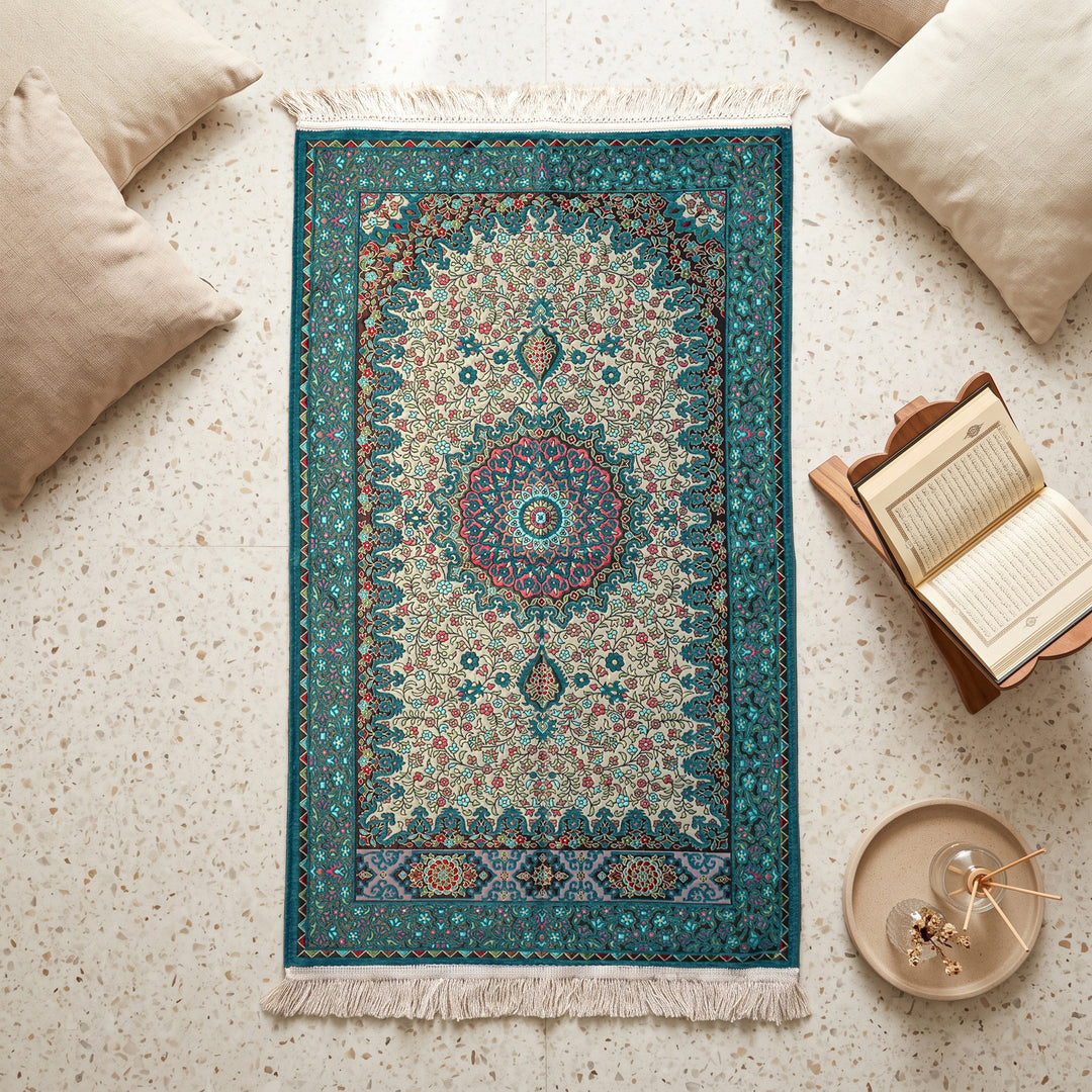 Floral Vine Prayer Rug in Turquoise - Cream, top view on the floor next to a Quran stand and cushions