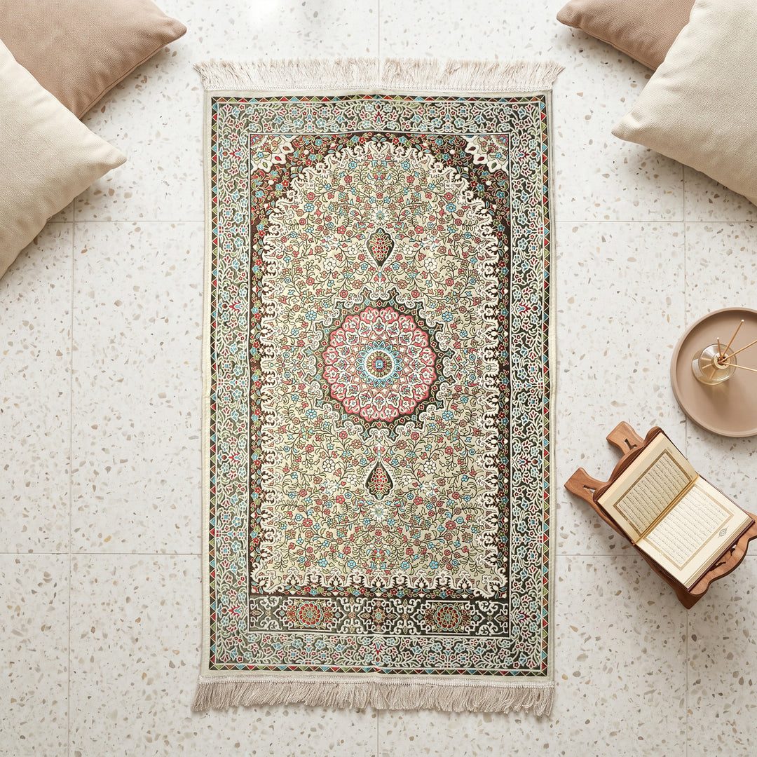 Floral Vine Prayer Rug in Cream - Beige, top view on the floor next to a Quran stand and cushions