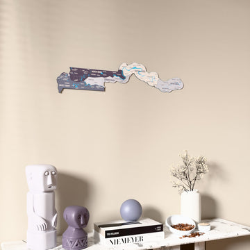 Nimbus Gambia wooden wall map on a beige wall above a console with figurines