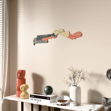Sage Gambia wooden wall map beside a sheer curtain, angled view