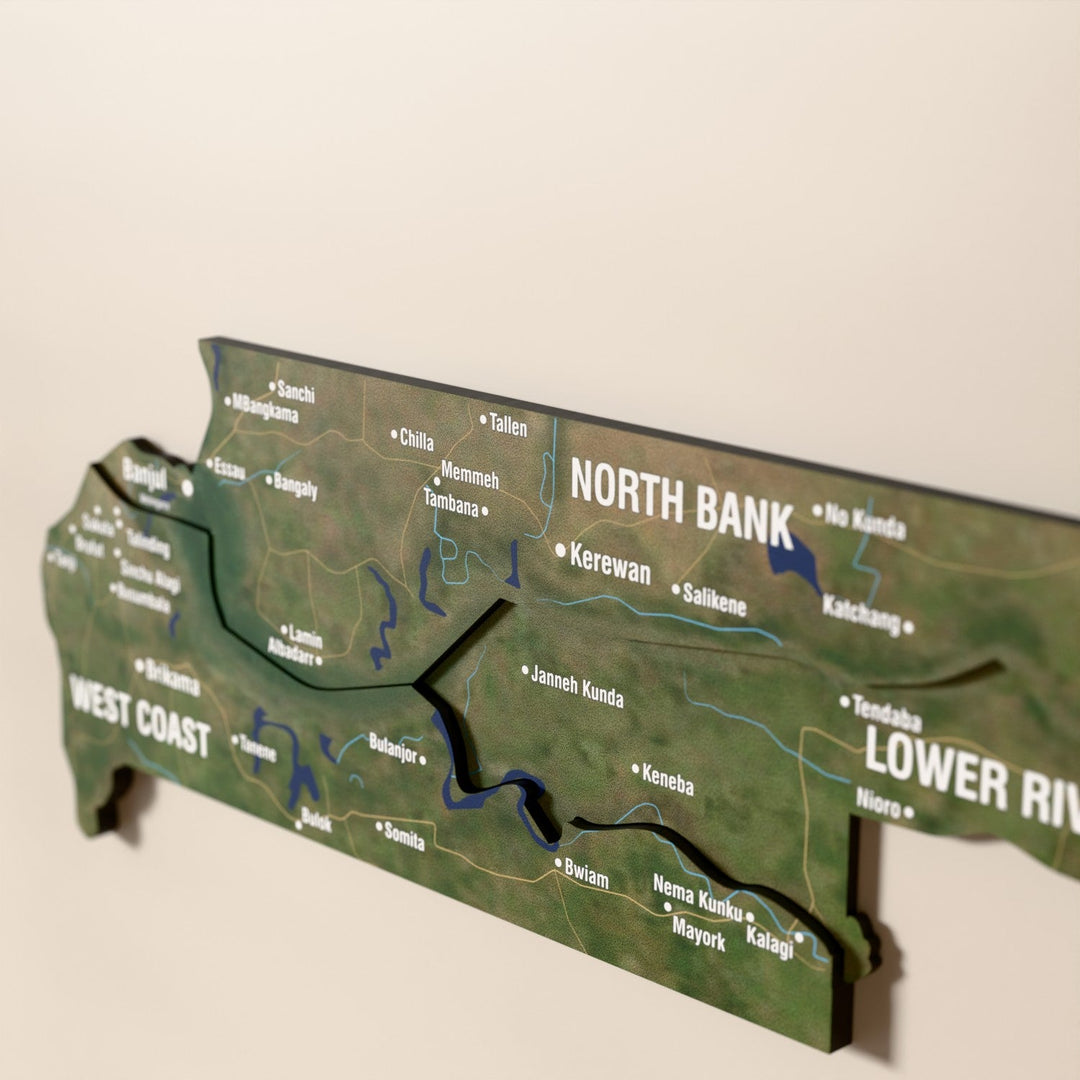 Close-up of the Satellite Gambia wooden wall map with layered regions and printed names