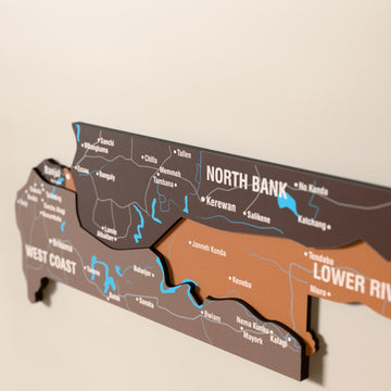 Close-up of the Soil Gambia wooden wall map with layered regions and printed names