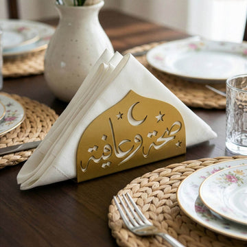 Saha w Afia metal napkin holder in gold on a set table