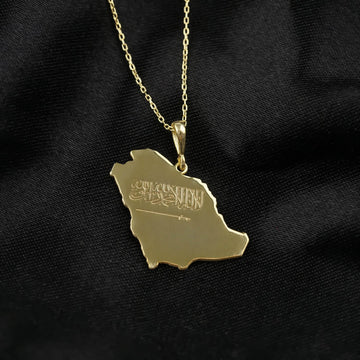 Gold Saudi Arabia map pendant with engraved Shahada and sword, front view with the bail and chain