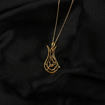 Small view of the Gold Tulip Mashallah necklace on its chain against black
