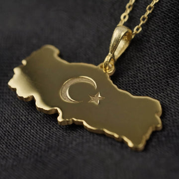 Close-up of the Gold Turkiye map pendant showing the engraved crescent and star