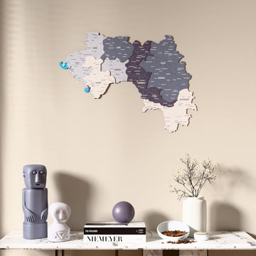Nimbus Guinea wooden wall map above a marble console, front view