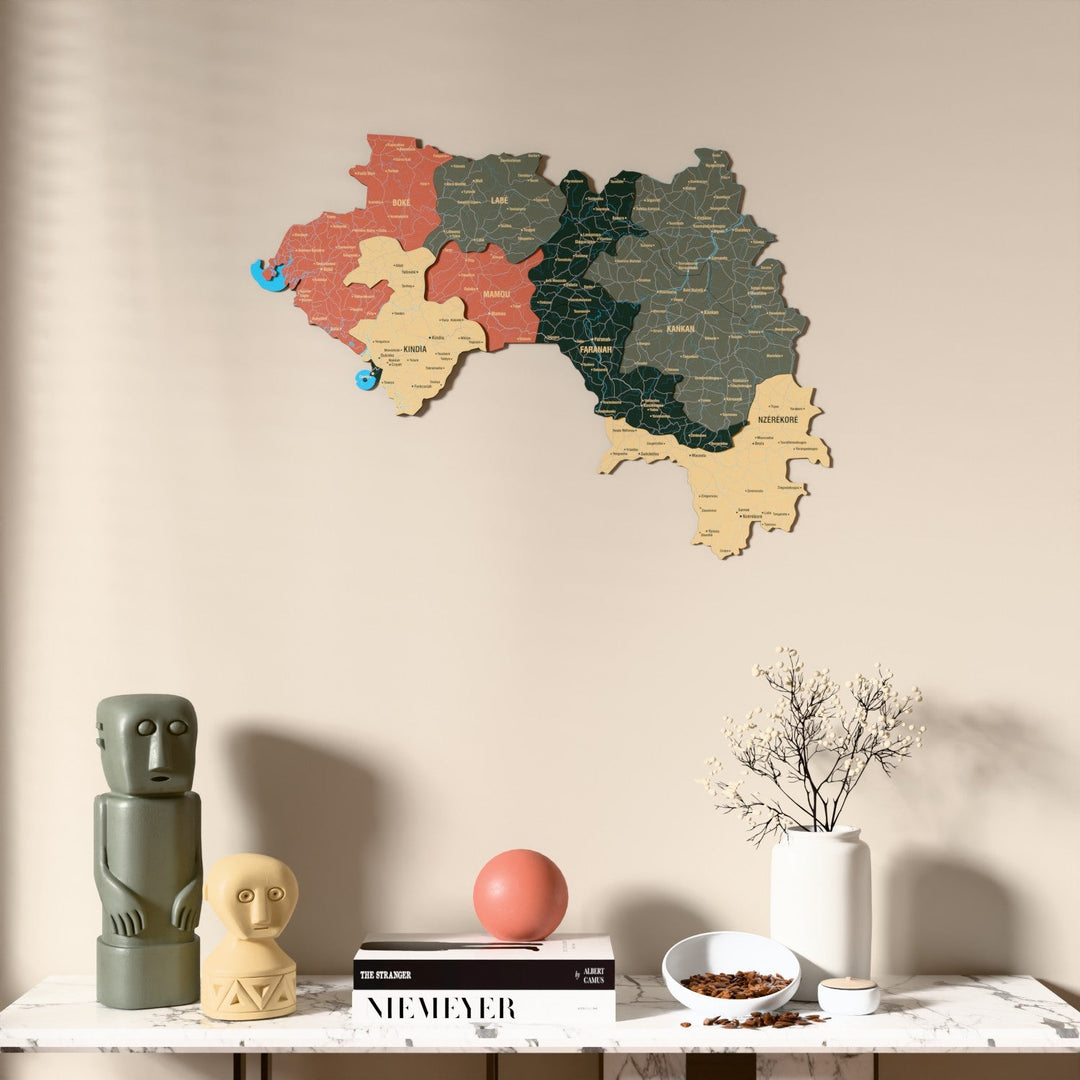 Sage Guinea wooden wall map above a marble console, front view