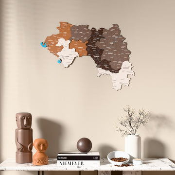 Soil Guinea wooden wall map above a marble console, front view