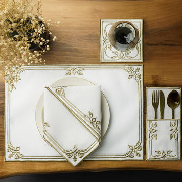 Gold interlocking scroll dining set place setting with folded napkin, coaster and pouch, overhead view