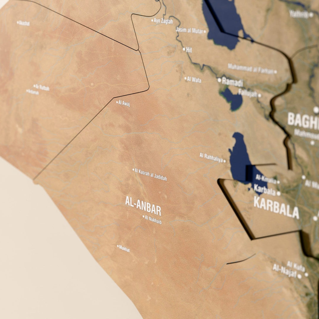 Close-up of the Satellite Iraq wooden wall map with layered regions and printed names