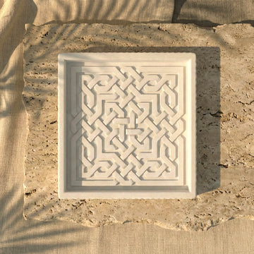 White ceramic Islamic geometric tray displayed on natural stone, modern tabletop home decor