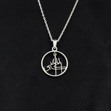 Silver Allahu Akbar Islamic necklace with a round calligraphy pendant on black fabric