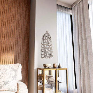 Vertikale Hadha Min Fadli Rabbi Wandkunst aus Metall in grauem Metallfinish neben einem Vorhang