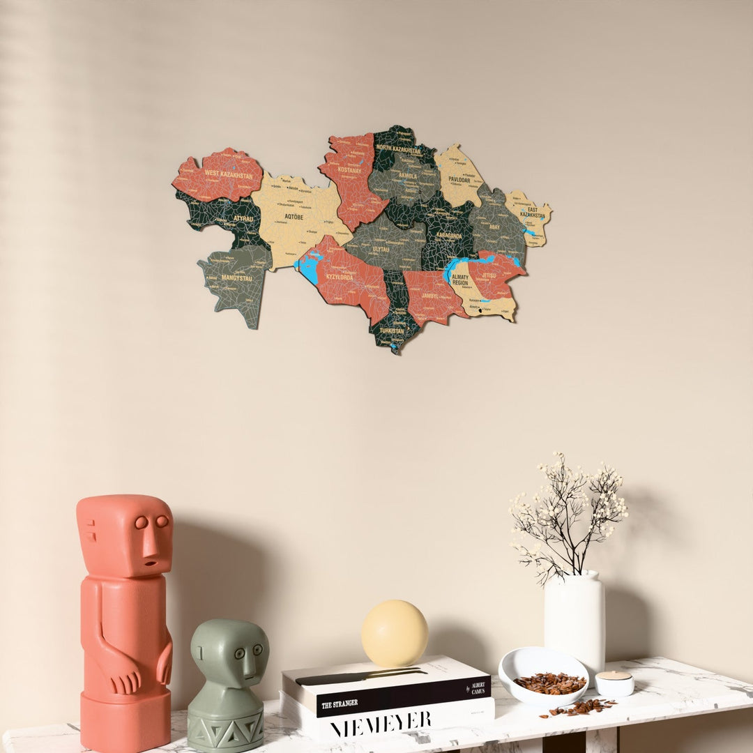 Sage Kazakhstan wooden wall map on a beige wall above a console with figurines
