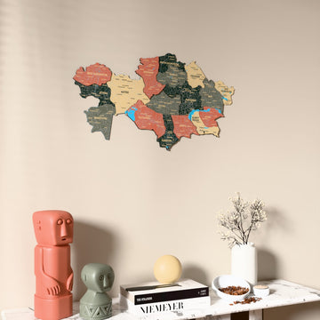 Sage Kazakhstan wooden wall map on a beige wall above a console with figurines