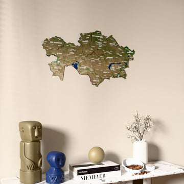 Satellite Kazakhstan wooden wall map on a beige wall above a console with figurines