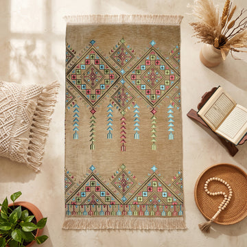 Kilim Prayer Rug in Beige, top view on the floor next to a Quran stand and cushions