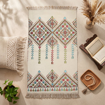 Kilim Prayer Rug in Cream, top view on the floor next to a Quran stand and cushions