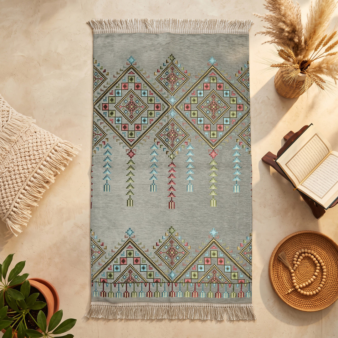 Kilim Prayer Rug in Gray, top view on the floor next to a Quran stand and cushions