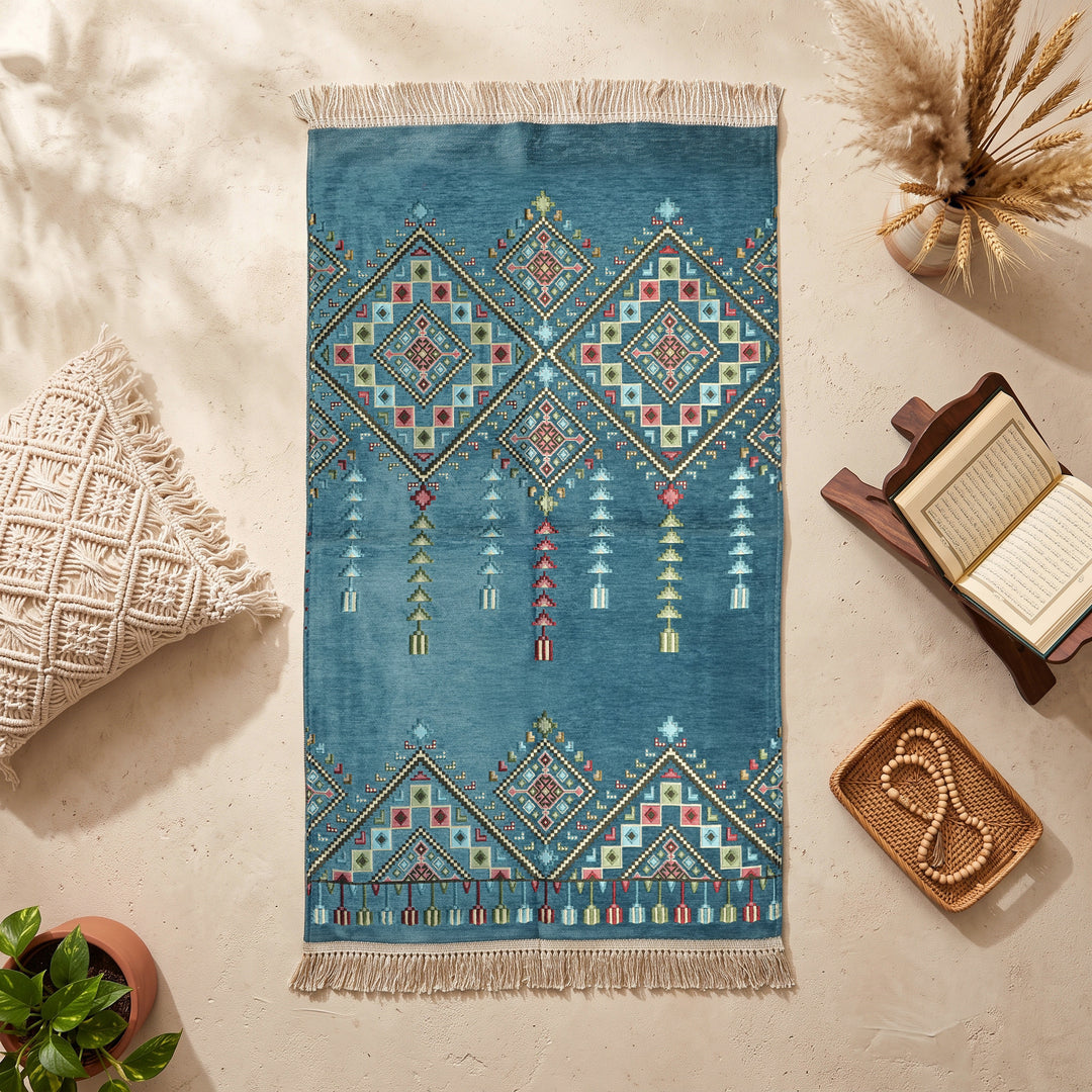 Kilim Prayer Rug in Petrol Blue, top view on the floor next to a Quran stand and cushions