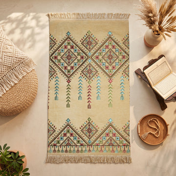Kilim Prayer Rug in Yellow, top view on the floor next to a Quran stand and cushions