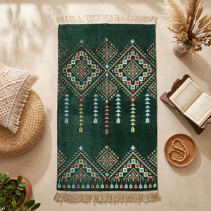 Kilim Prayer Rug in Emerald Green, top view on the floor next to a Quran stand and cushions