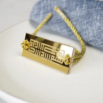Kufic Bismillah napkin holder with cord on a set table