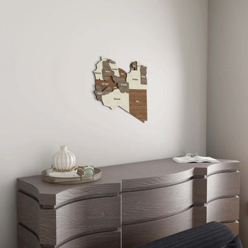Libya wooden wall map on a white wall above a gray wooden dresser
