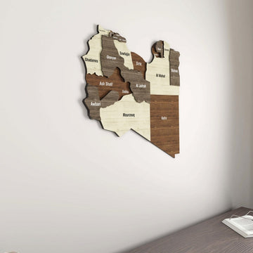 Libya wooden wall map seen from the side on a white wall above a corner shelf