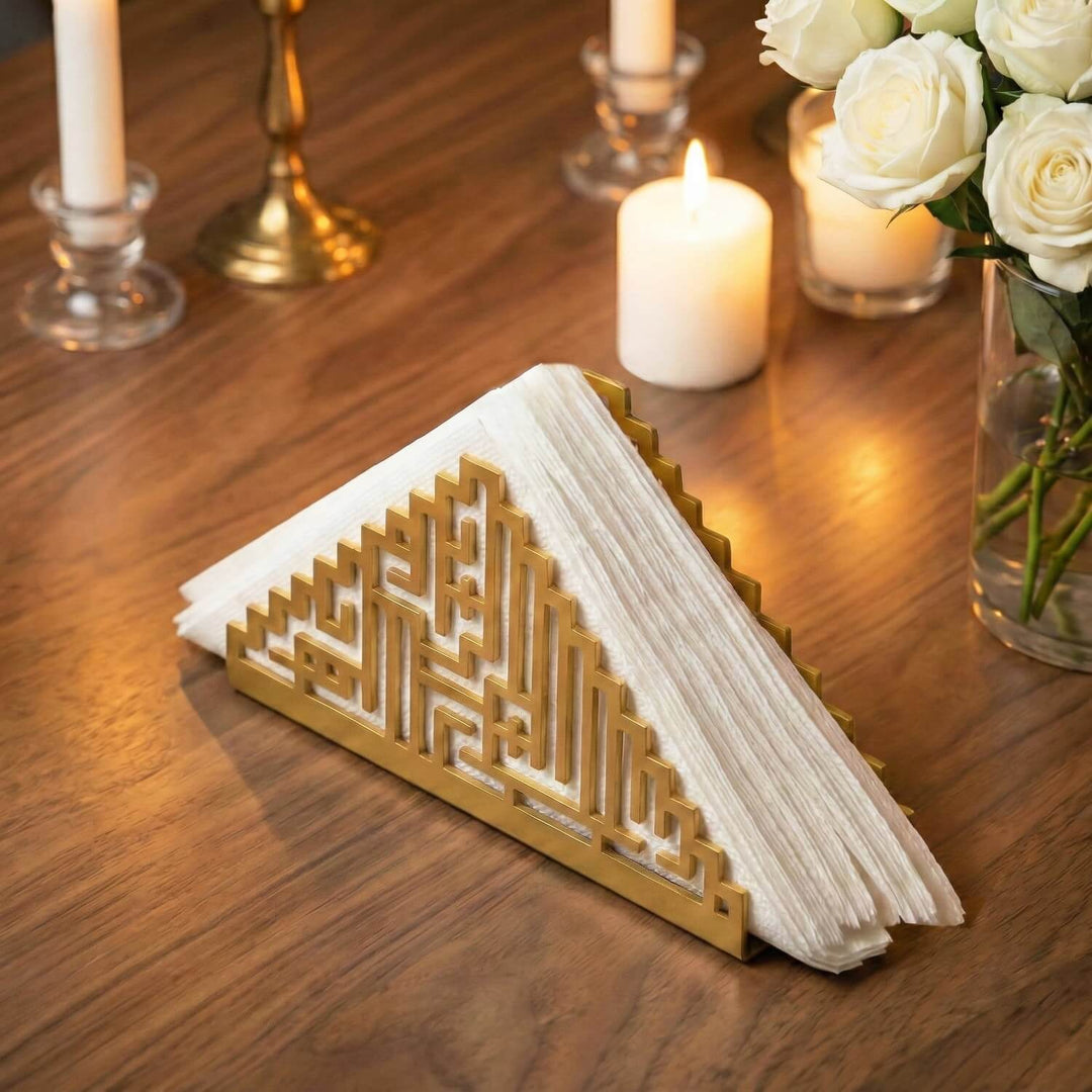 Bismillah Kufic metal napkin holder in gold on a set table