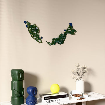 Satellite Malaysia wooden wall map on a beige wall above a console with figurines