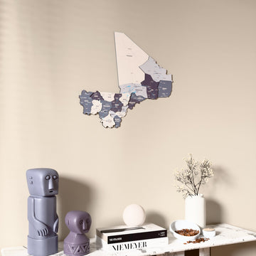 Nimbus Mali wooden wall map on a beige wall above a console with figurines