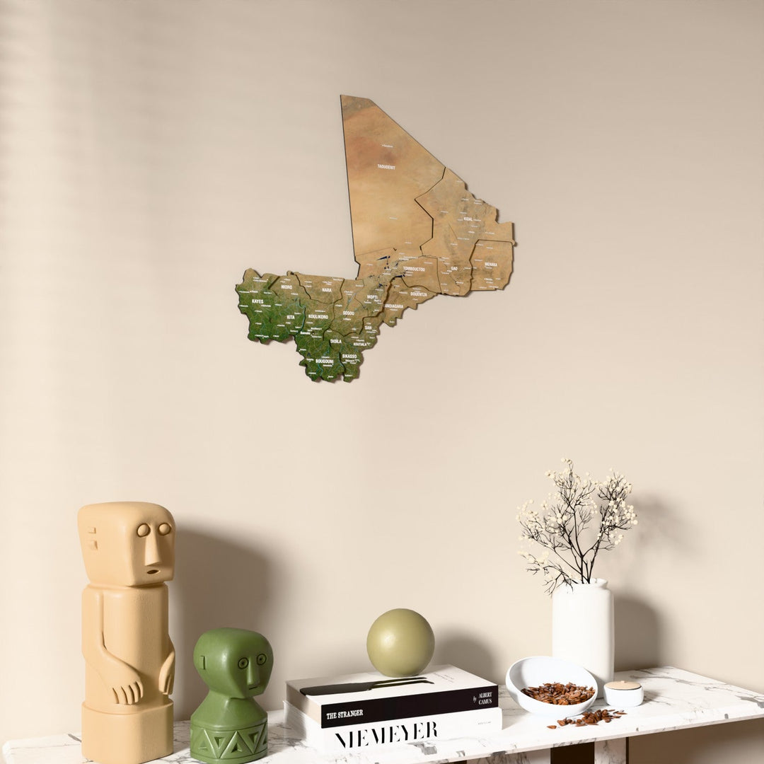 Satellite Mali wooden wall map on a beige wall above a console with figurines