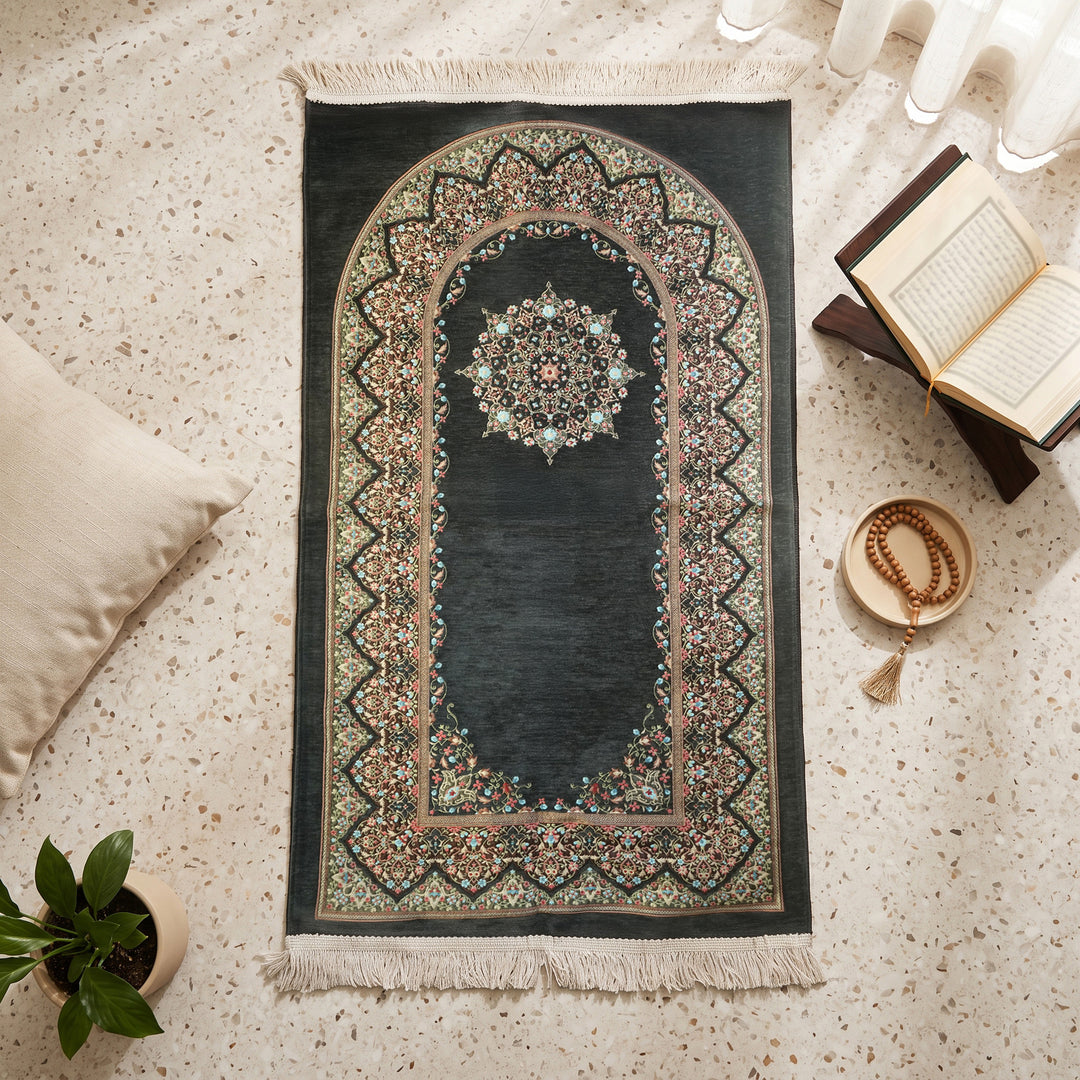 Mihrab Prayer Rug in Anthracite, top view on the floor next to a Quran stand and cushions