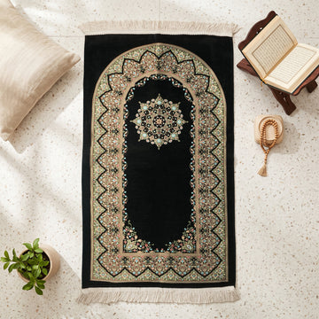 Mihrab Prayer Rug in Black, top view on the floor next to a Quran stand and cushions