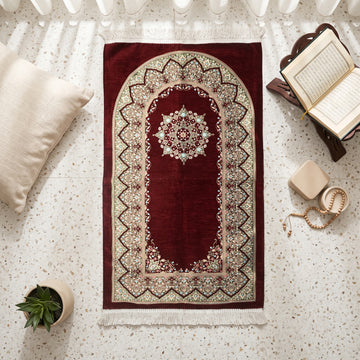 Mihrab Prayer Rug in Burgundy, top view on the floor next to a Quran stand and cushions