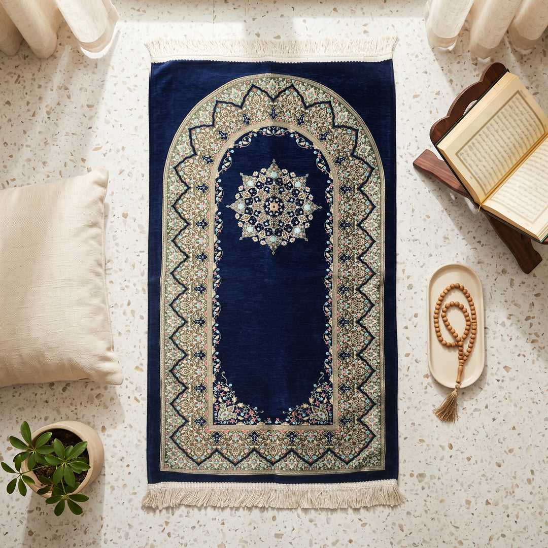 Mihrab Prayer Rug in Navy, top view on the floor next to a Quran stand and cushions