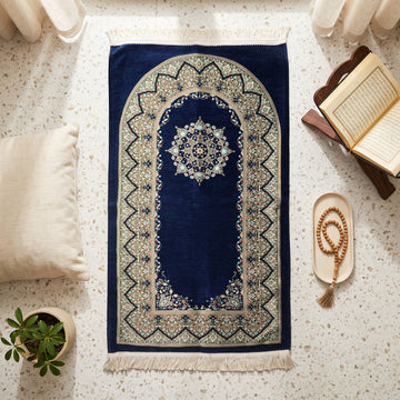 Mihrab Prayer Rug in Navy, top view on the floor next to a Quran stand and cushions