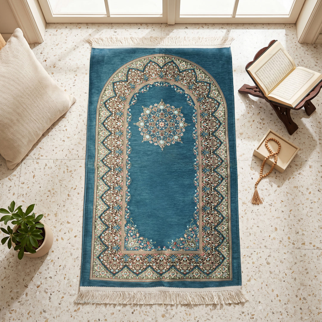 Mihrab Prayer Rug in Petrol Blue, top view on the floor next to a Quran stand and cushions