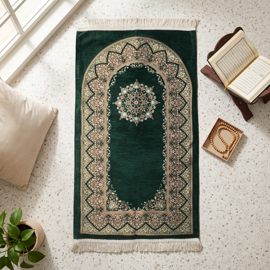 Mihrab Prayer Rug in Emerald Green, top view on the floor next to a Quran stand and cushions