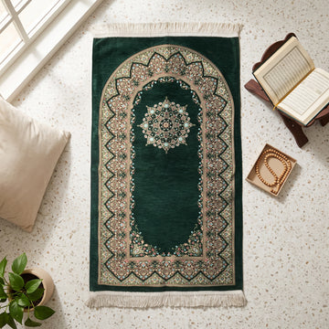Mihrab Prayer Rug in Emerald Green, top view on the floor next to a Quran stand and cushions