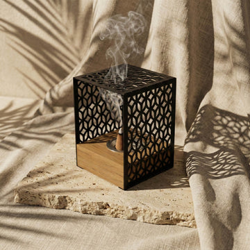 Black Petal Lattice wooden base mabkhara, angled view showing the incense cone inside the frame