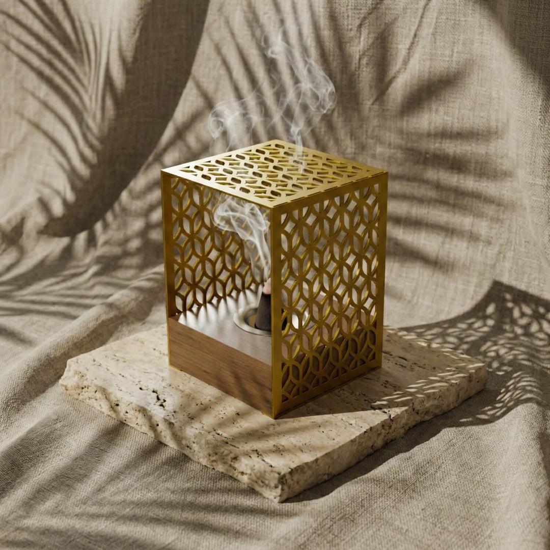 Gold Petal Lattice wooden base mabkhara, distant view with shadows of palm leaves on the cloth